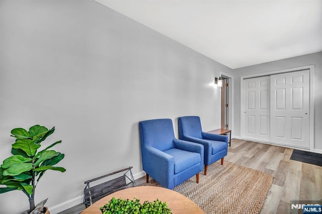 sitting room with wood finished floors and baseboards
