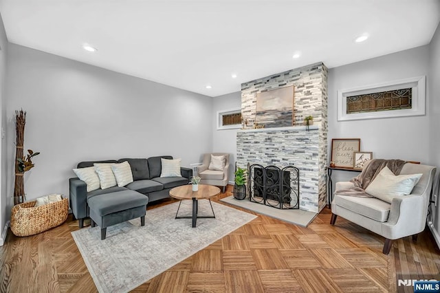 living area with recessed lighting and a large fireplace