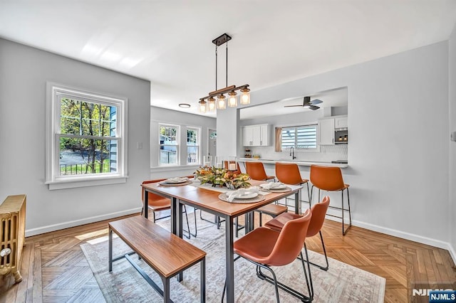 dining room featuring baseboards and a ceiling fan