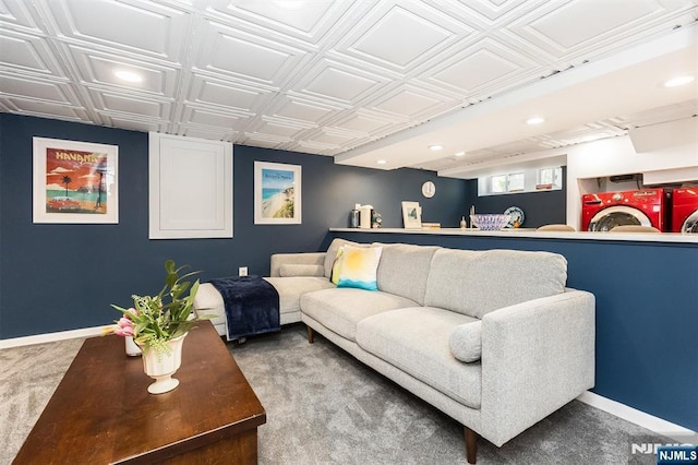 living area featuring an ornate ceiling, carpet, and baseboards