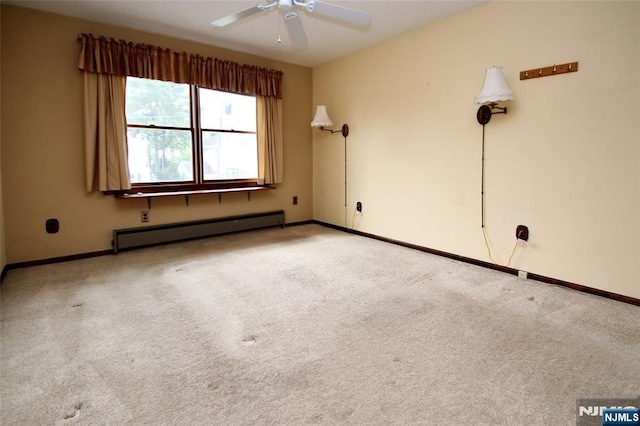 carpeted empty room featuring baseboards, a ceiling fan, and a baseboard radiator