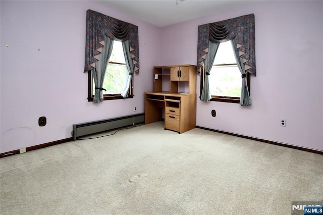 unfurnished bedroom with a baseboard radiator, baseboards, and light carpet