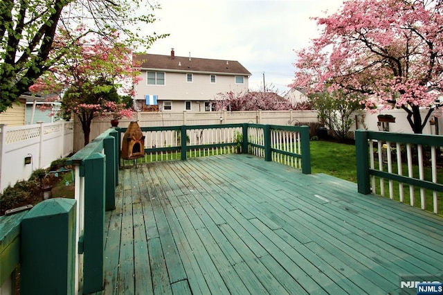 wooden terrace featuring a fenced backyard