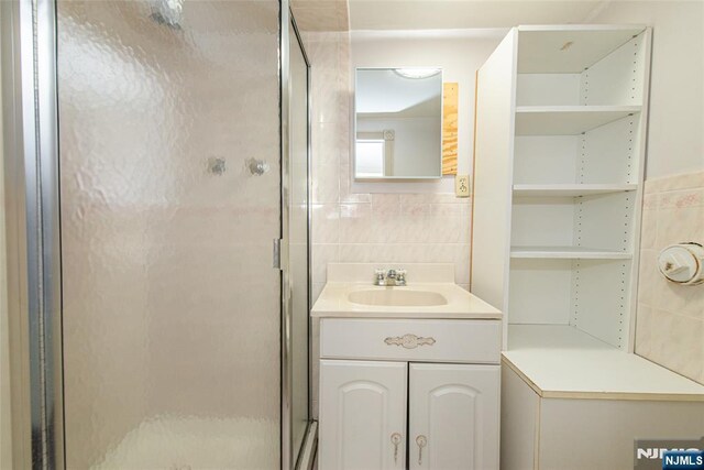 117 Saint Marys Pl, Nutley, NJ 07110 - full bathroom featuring vanity, a stall shower, and tile walls