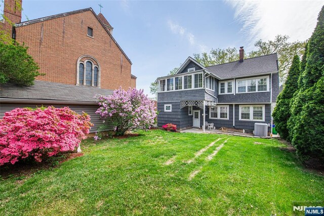 117 Saint Marys Pl, Nutley, NJ 07110 - rear view of house featuring central AC unit, a yard, and a patio area