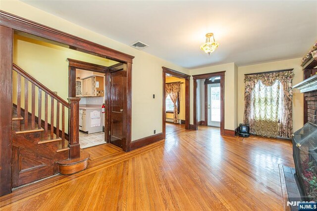 117 Saint Marys Pl, Nutley, NJ 07110 - entryway with a chandelier, baseboards, wood finished floors, visible vents, and stairway