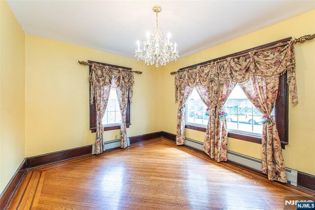 117 Saint Marys Pl, Nutley, NJ 07110 - empty room with an inviting chandelier and wood finished floors