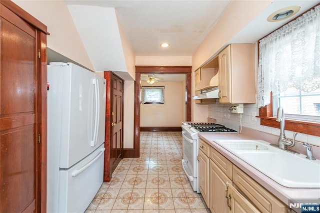 117 Saint Marys Pl, Nutley, NJ 07110 - kitchen with light countertops, baseboards, a sink, under cabinet range hood, and white appliances