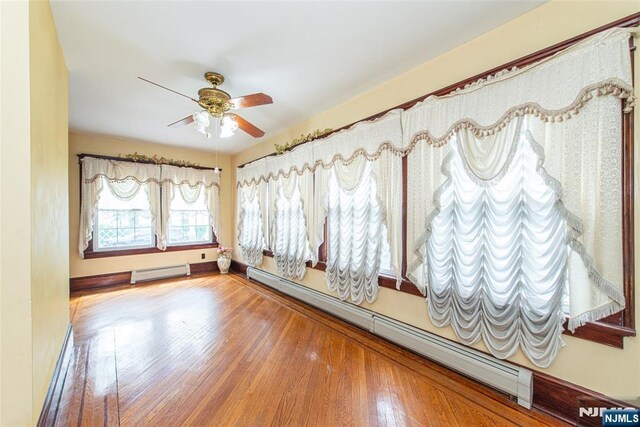 117 Saint Marys Pl, Nutley, NJ 07110 - unfurnished room with ceiling fan, baseboard heating, a baseboard heating unit, and wood finished floors