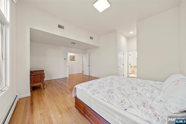 bedroom featuring a baseboard heating unit, recessed lighting, light wood-style flooring, and visible vents