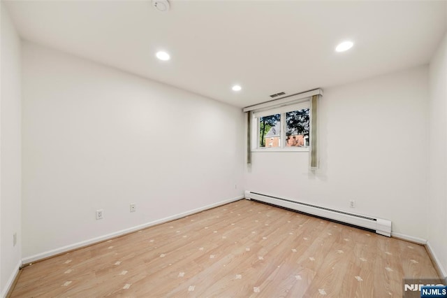 unfurnished room featuring recessed lighting, baseboards, a baseboard heating unit, and wood finished floors