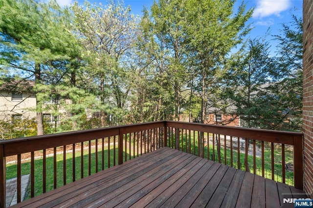 wooden deck with a lawn