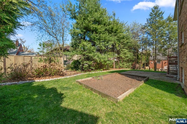 view of yard featuring fence and stairway