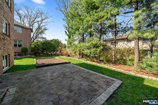 view of yard featuring fence and a patio area