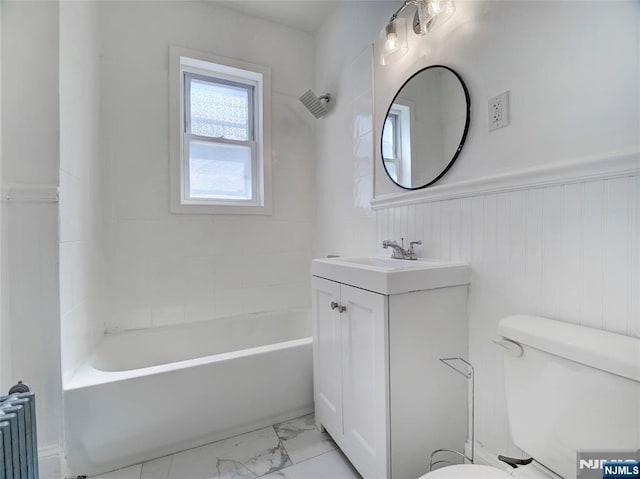 full bathroom featuring a wainscoted wall, toilet, bathing tub / shower combination, vanity, and marble finish floor