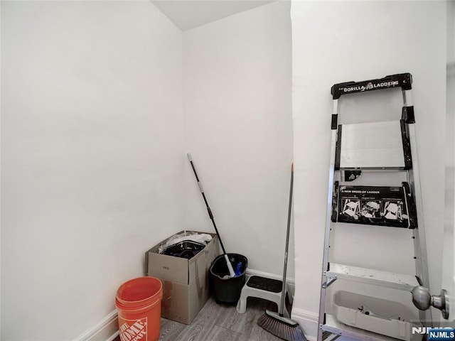 interior space featuring baseboards and wood finished floors