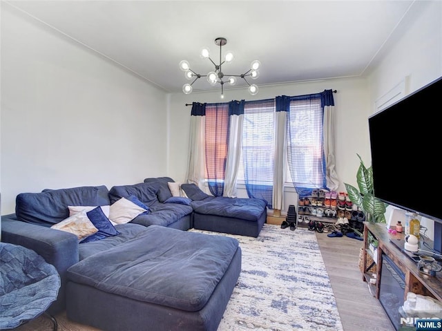 living room with an inviting chandelier and light wood-style floors
