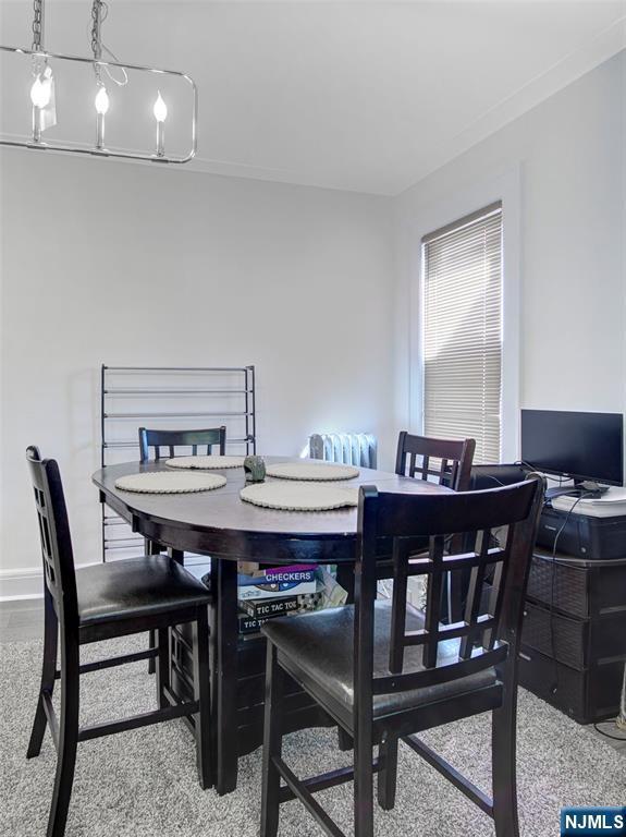 carpeted dining room with baseboards