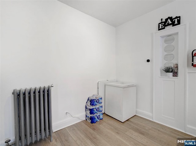 washroom featuring radiator heating unit and wood finished floors