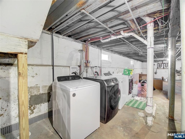 clothes washing area featuring washer and dryer and laundry area