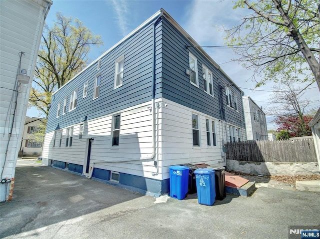 view of side of home with fence
