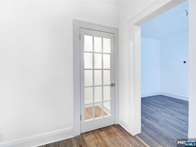 entryway featuring baseboards and wood finished floors