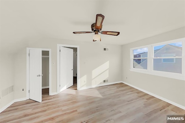 unfurnished bedroom with baseboards, visible vents, and light wood-style floors