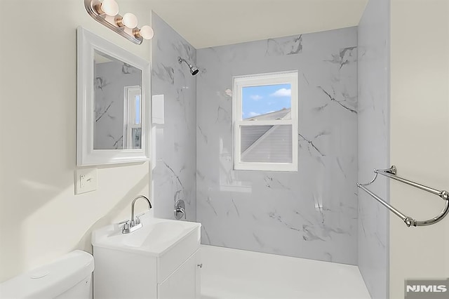 bathroom with toilet, bathtub / shower combination, and vanity