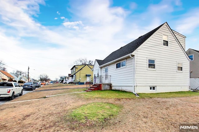 view of property exterior featuring a lawn