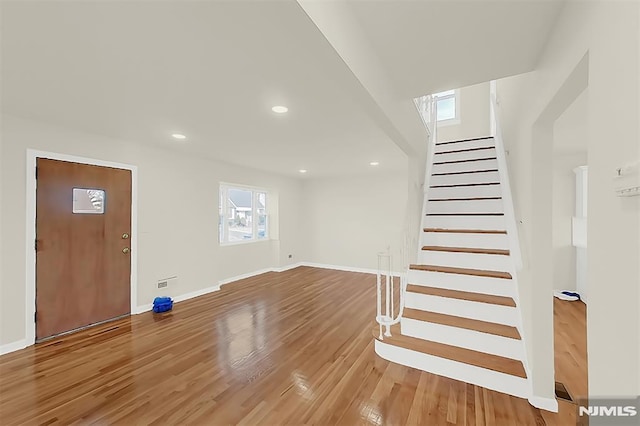 entrance foyer featuring baseboards, recessed lighting, stairway, and light wood-type flooring
