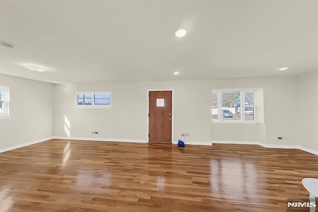 interior space featuring wood finished floors, recessed lighting, visible vents, and baseboards