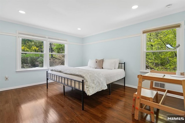 bedroom featuring baseboards, visible vents, wood finished floors, and recessed lighting