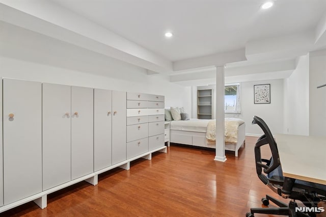 bedroom with recessed lighting and wood finished floors