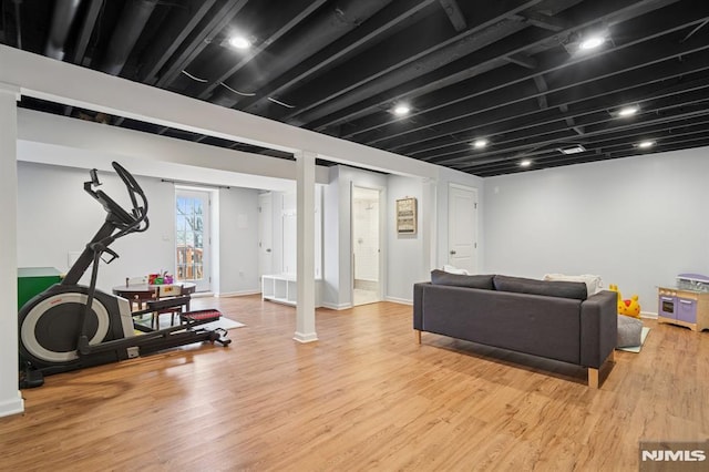 living area with baseboards and light wood finished floors
