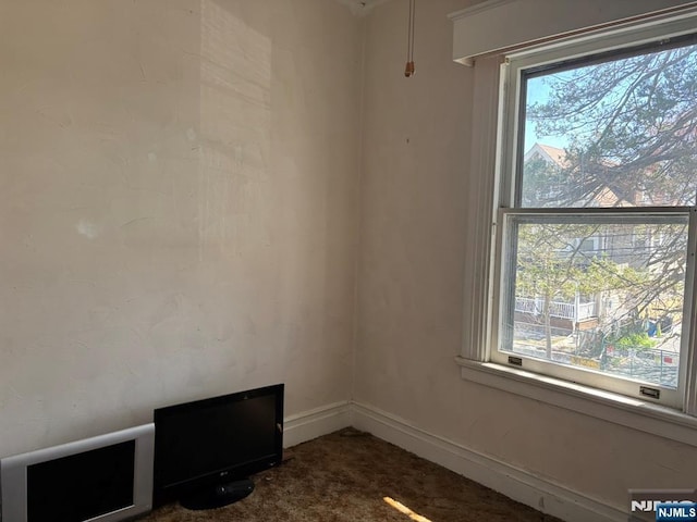 empty room featuring dark carpet