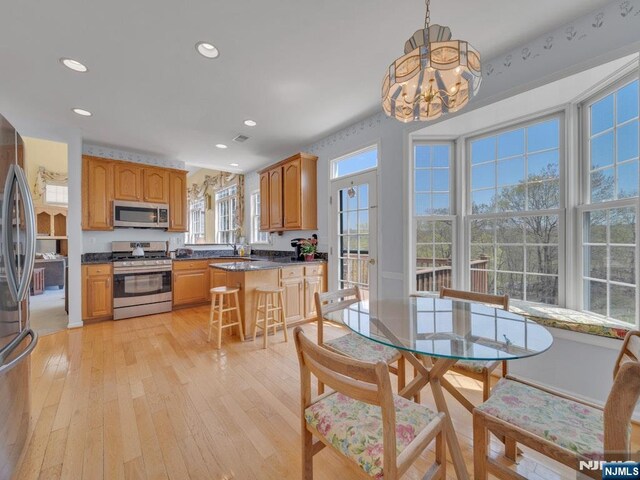 6 Knollwoods, Oakland, NJ 07436 - kitchen with light wood-style flooring, dark countertops, stainless steel appliances, an inviting chandelier, and recessed lighting