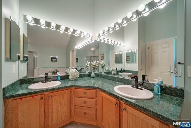 6 Knollwoods, Oakland, NJ 07436 - full bath with lofted ceiling, tile patterned floors, double vanity, and a sink