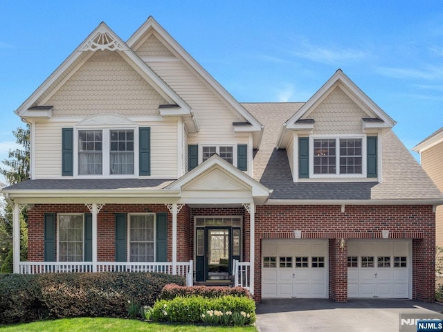 6 Knollwoods, Oakland, NJ 07436 - craftsman-style house with covered porch, brick siding, aphalt driveway, and an attached garage