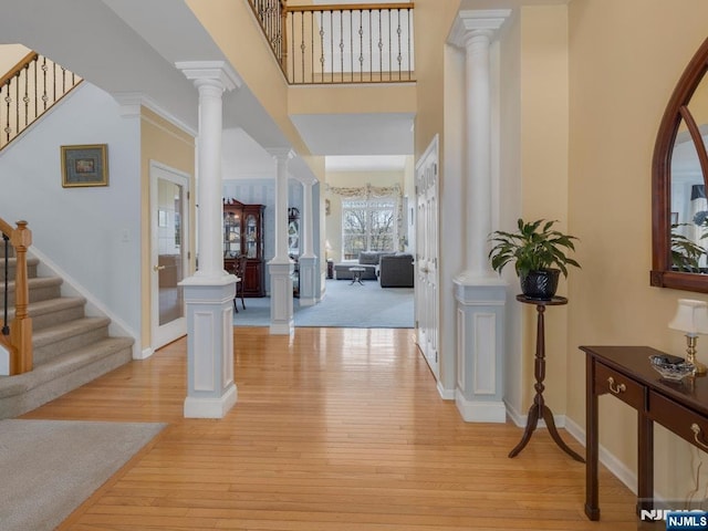 6 Knollwoods, Oakland, NJ 07436 - foyer entrance featuring stairway, light wood finished floors, and decorative columns