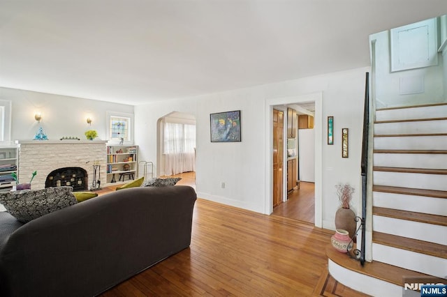 884 Helen St, Teaneck, NJ 07666 - living area featuring wood finished floors, stairway, baseboards, and a fireplace