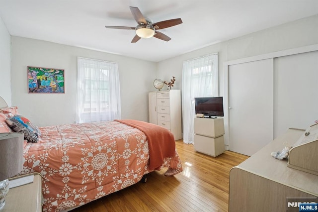 884 Helen St, Teaneck, NJ 07666 - bedroom featuring multiple windows, light wood-style flooring, a closet, and ceiling fan