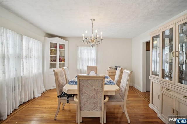 884 Helen St, Teaneck, NJ 07666 - dining room with a chandelier and light wood-style flooring