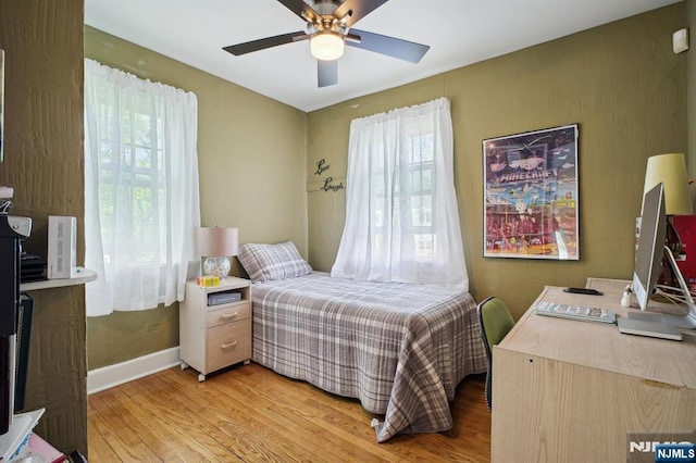 884 Helen St, Teaneck, NJ 07666 - bedroom featuring multiple windows, light wood-type flooring, and an office area