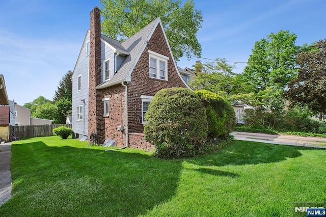 884 Helen St, Teaneck, NJ 07666 - view of home's exterior featuring a chimney and brick siding