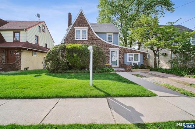 884 Helen St, Teaneck, NJ 07666 - view of front of property with a front lawn, a chimney, and brick siding
