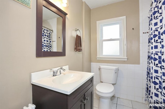 bathroom with vanity, tile patterned flooring, toilet, tile walls, and a shower with shower curtain