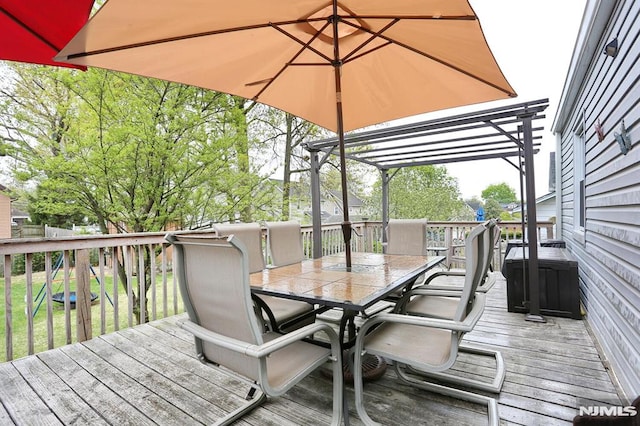 deck featuring a pergola and outdoor dining area