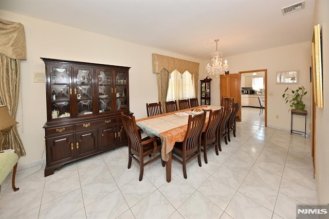 18 Radcliffe Ave, Woodland Park, NJ 07424 - dining area with light tile patterned floors, visible vents, and a notable chandelier