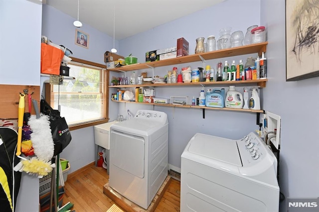 18 Radcliffe Ave, Woodland Park, NJ 07424 - clothes washing area featuring separate washer and dryer, baseboards, laundry area, and light wood finished floors