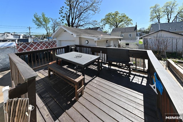 18 Radcliffe Ave, Woodland Park, NJ 07424 - wooden terrace with a garage, fence, outdoor dining area, an outbuilding, and a residential view